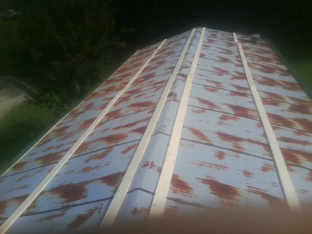 Rusted metal roof panels with new wood purlins before replacement — Storm Damage Roof Repair in Roseburg by Roofing Brothers